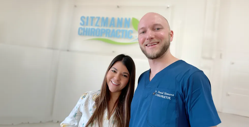 Dr. Daniel Sitzmann and his wife inside the chiropractic clinic