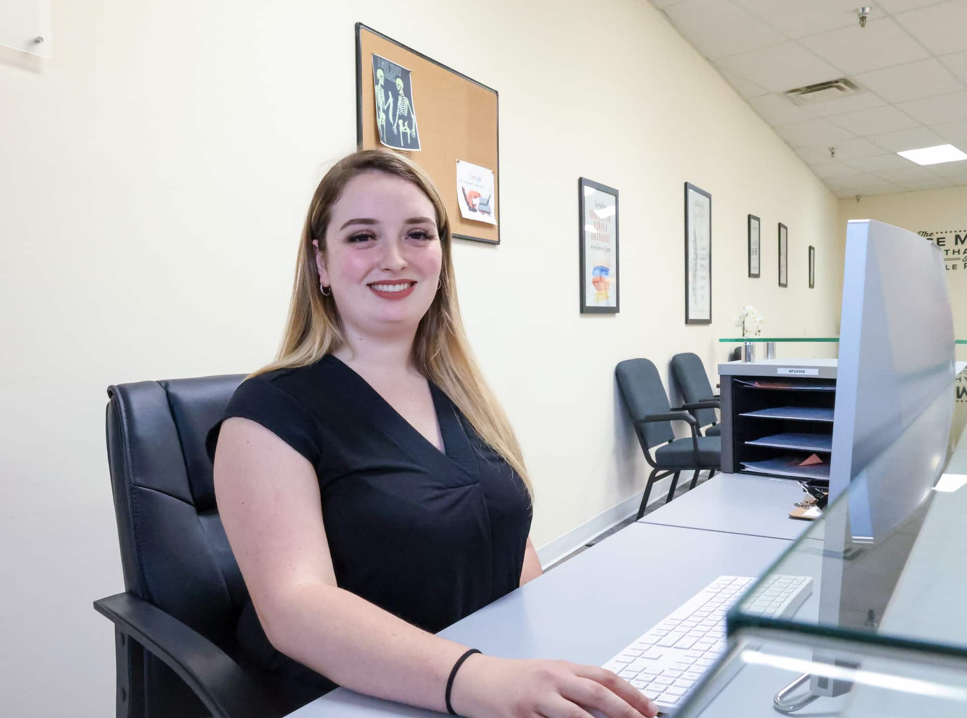 Front desk executive Carly working on computer