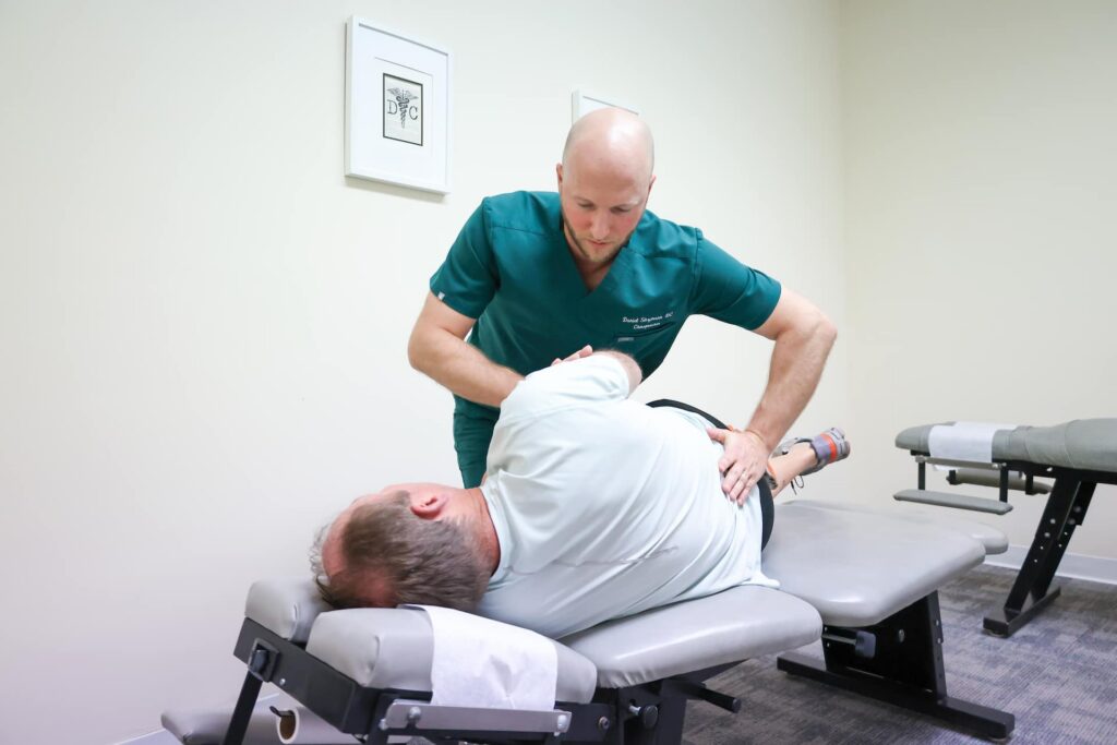Chiropractor performing back adjustment
