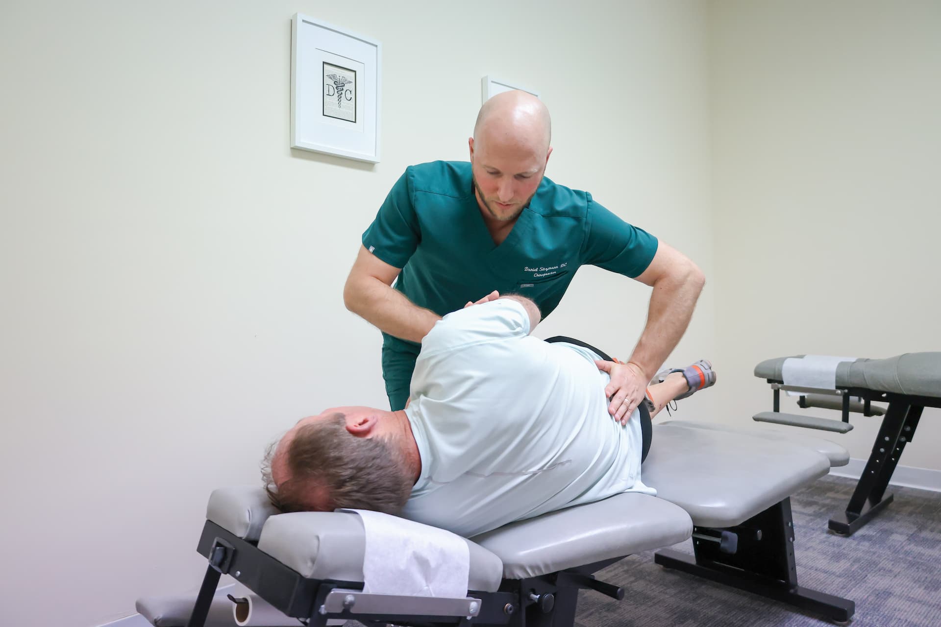 Chiropractor treating back pain wide view