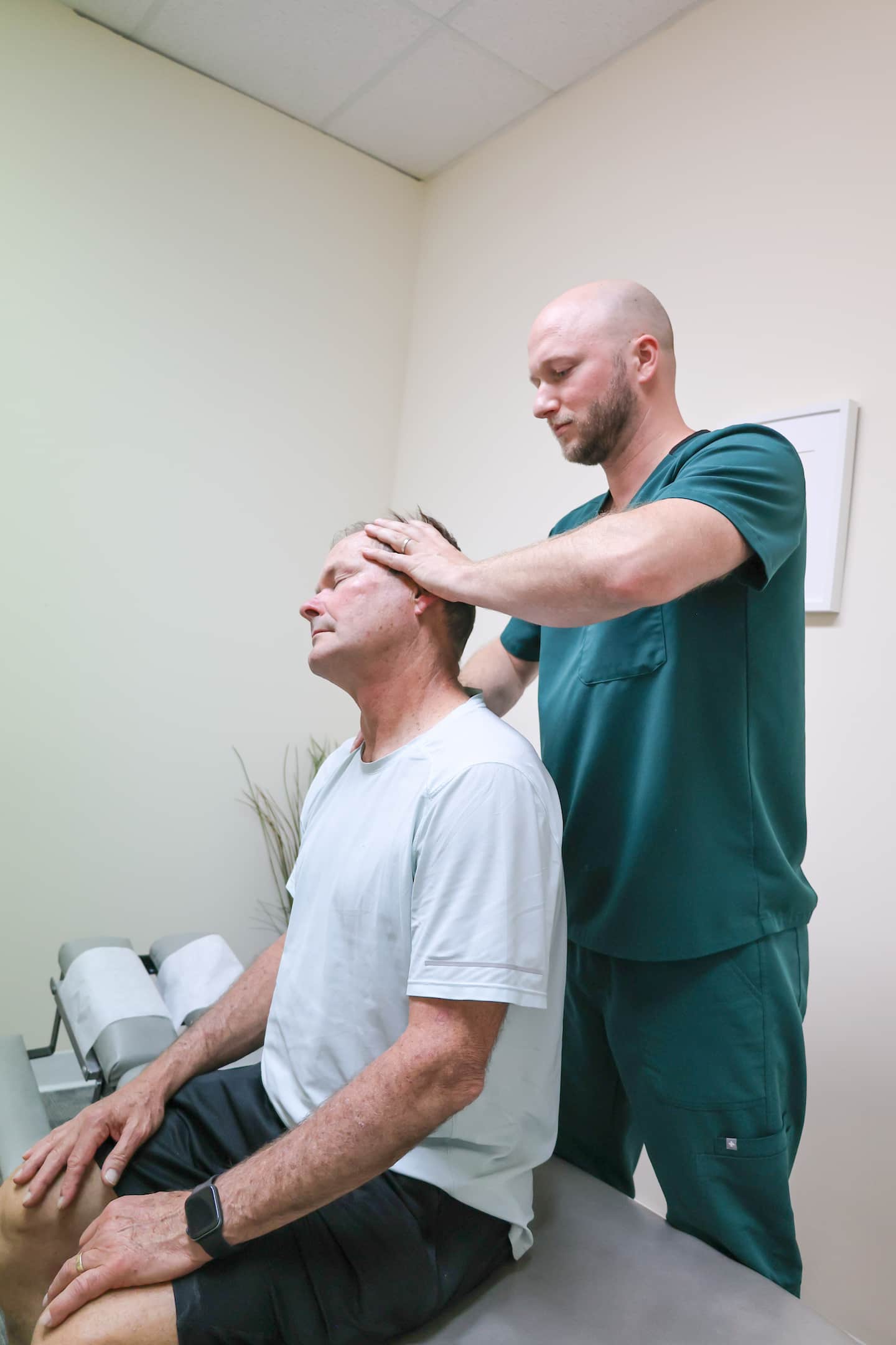 Chiropractor providing head massage