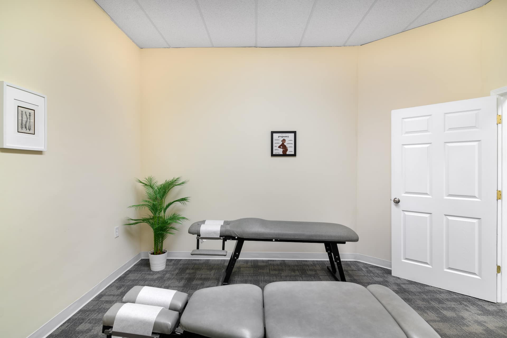 Professional Gonstead chiropractic table in a clean, modern treatment room designed for precise spinal adjustments and therapy