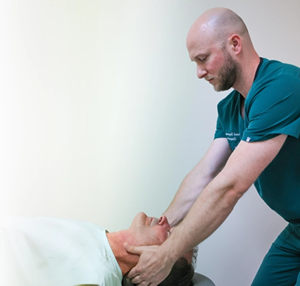 Dr. Sitzmann performing neck adjustment on patient in Lincolnton NC clinic
