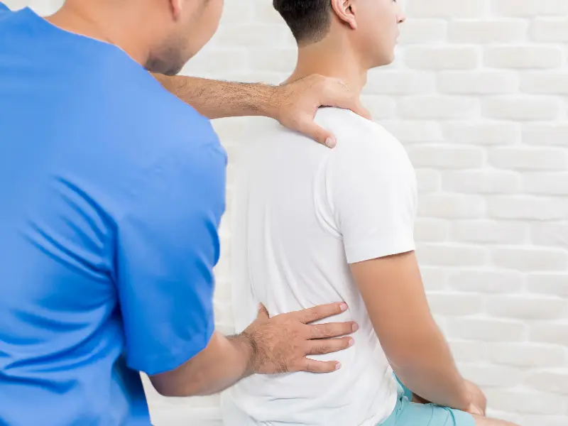 Professional chiropractor assessing a patient's spine and lower back for misalignments to provide effective back pain relief.