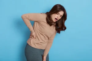 Woman experiencing pain in shoulder, hip, and knee joints