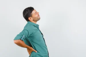 Person holding lower back pain after medication no longer provides relief