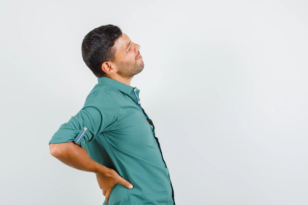 Person holding lower back pain after medication no longer provides relief