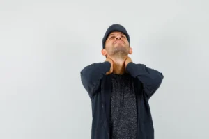 Person cracking neck at home to relieve stiffness and tension